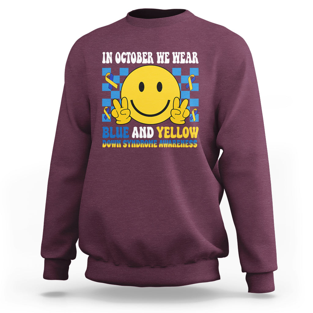 Maroon sweatshirt with yellow smiley and blue-and-yellow awareness text on back.
