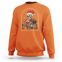 Orange crewneck Christmas skeleton sweatshirt with front graphic holding a steaming coffee mug