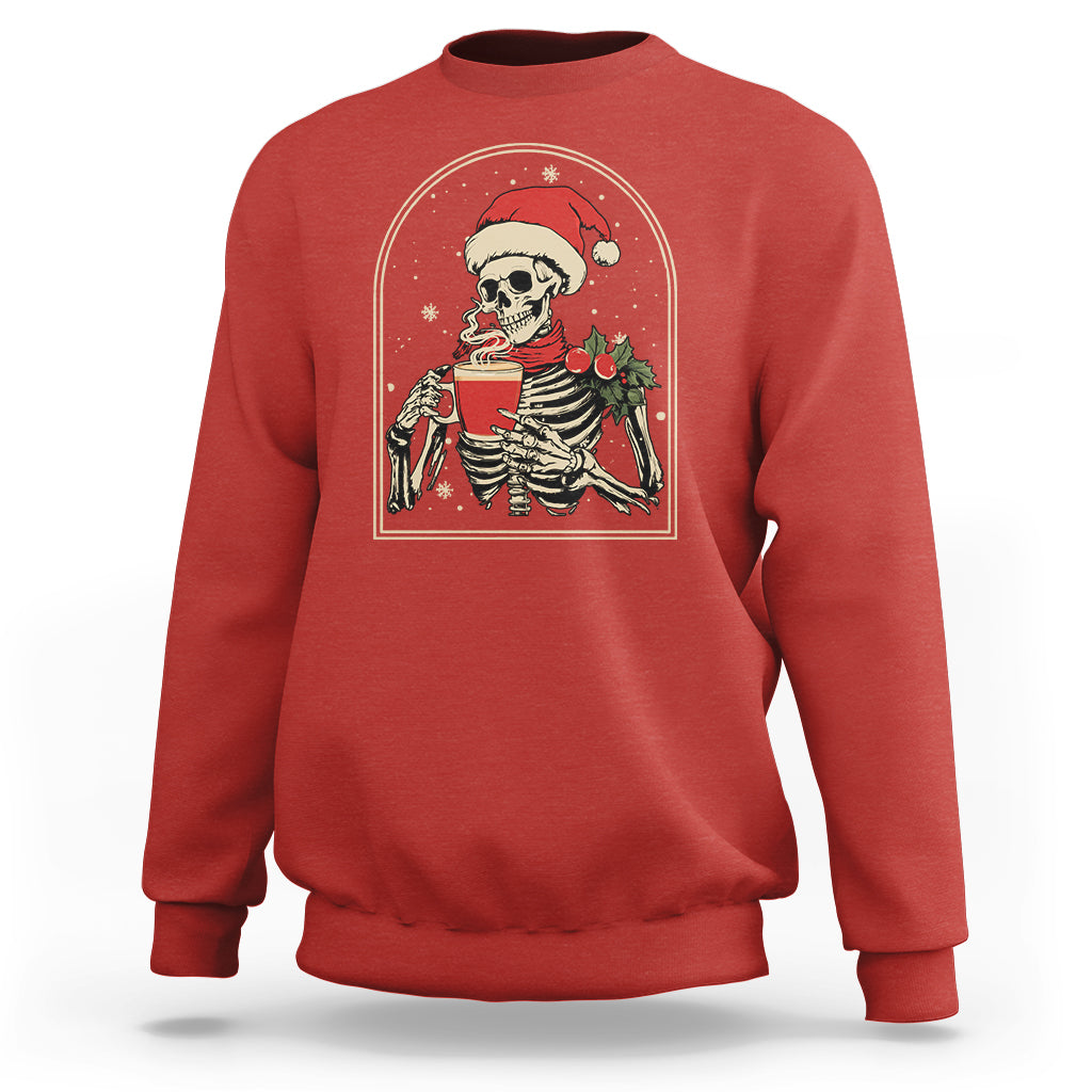 Red crewneck Christmas skeleton sweatshirt with front graphic of a skull holding a coffee mug