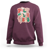 Maroon crewneck sweatshirt with colorful 'joy' holiday graphic on front.