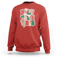 Red crewneck sweatshirt with colorful 'joy' holiday graphic on front.