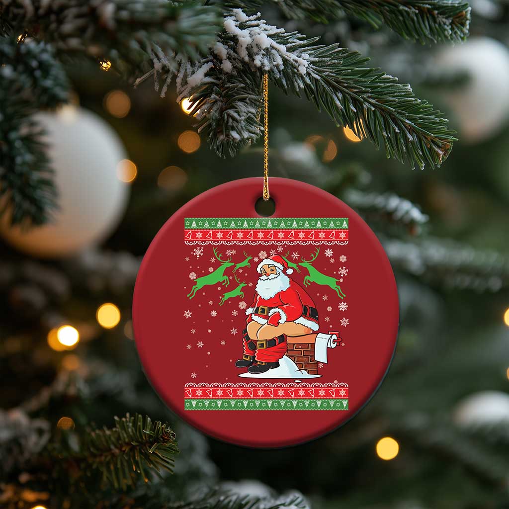 Red round Santa Christmas ornament hanging from a gold string on a tree