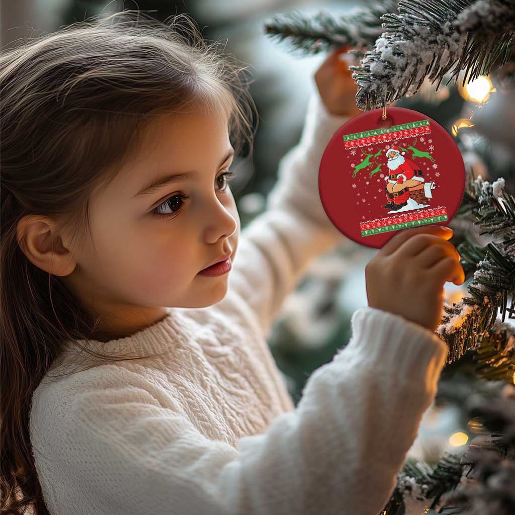 Red round Santa Christmas ornament held near a Christmas tree by a child