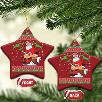 Red star-shaped Christmas ornament with Santa chimney scene and gold hanging string