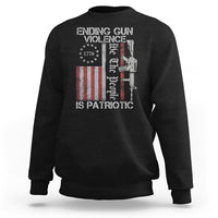 Black crewneck sweatshirt with patriotic gun-violence graphic and text