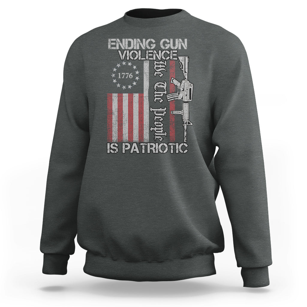 Dark heather crewneck sweatshirt with patriotic gun-violence graphic and text