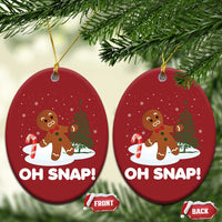 Two red circular “OH SNAP!” gingerbread ornaments hanging from gold cords