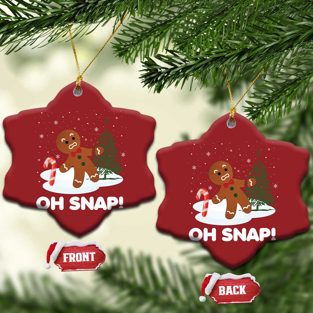 Two red snowflake-shaped “OH SNAP!” gingerbread ornaments with gold cords and front/back tags