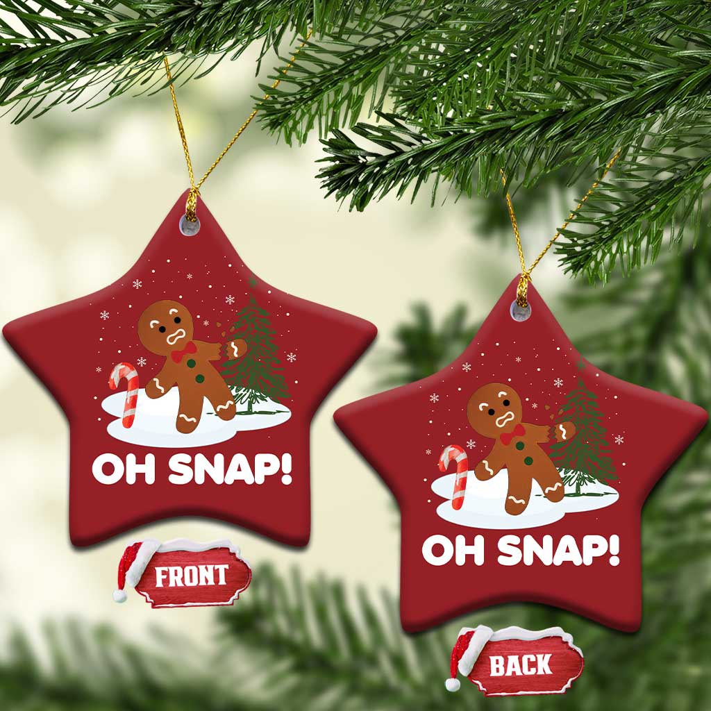 Two red star-shaped “OH SNAP!” gingerbread ornaments with gold cords and front/back tags