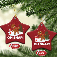 Two red star-shaped “OH SNAP!” gingerbread ornaments with gold cords and front/back tags