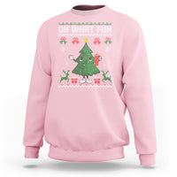 Light pink Christmas sweatshirt with holiday tree graphic and snowflake accents