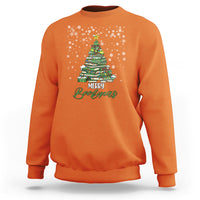 Orange crewneck sweatshirt with pine tree holiday graphic and “Merry Bookmas” text