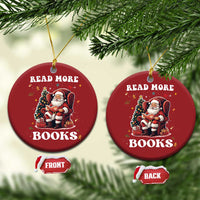 Two red round Christmas ornaments on a tree: “READ MORE BOOKS” with Santa reading