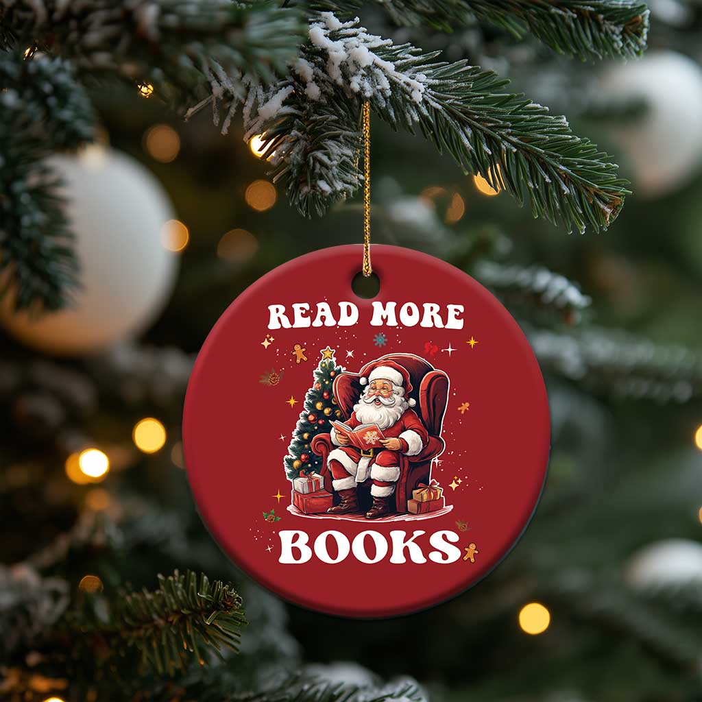Red round Christmas ornament hanging on a tree with Santa and “READ MORE BOOKS”
