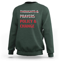 Forest green crewneck sweatshirt with red 'Thoughts & Prayers Policy & Change' print