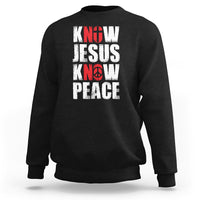 Black sweatshirt with 'KNOW JESUS KNOW PEACE' graphic in white/red text.