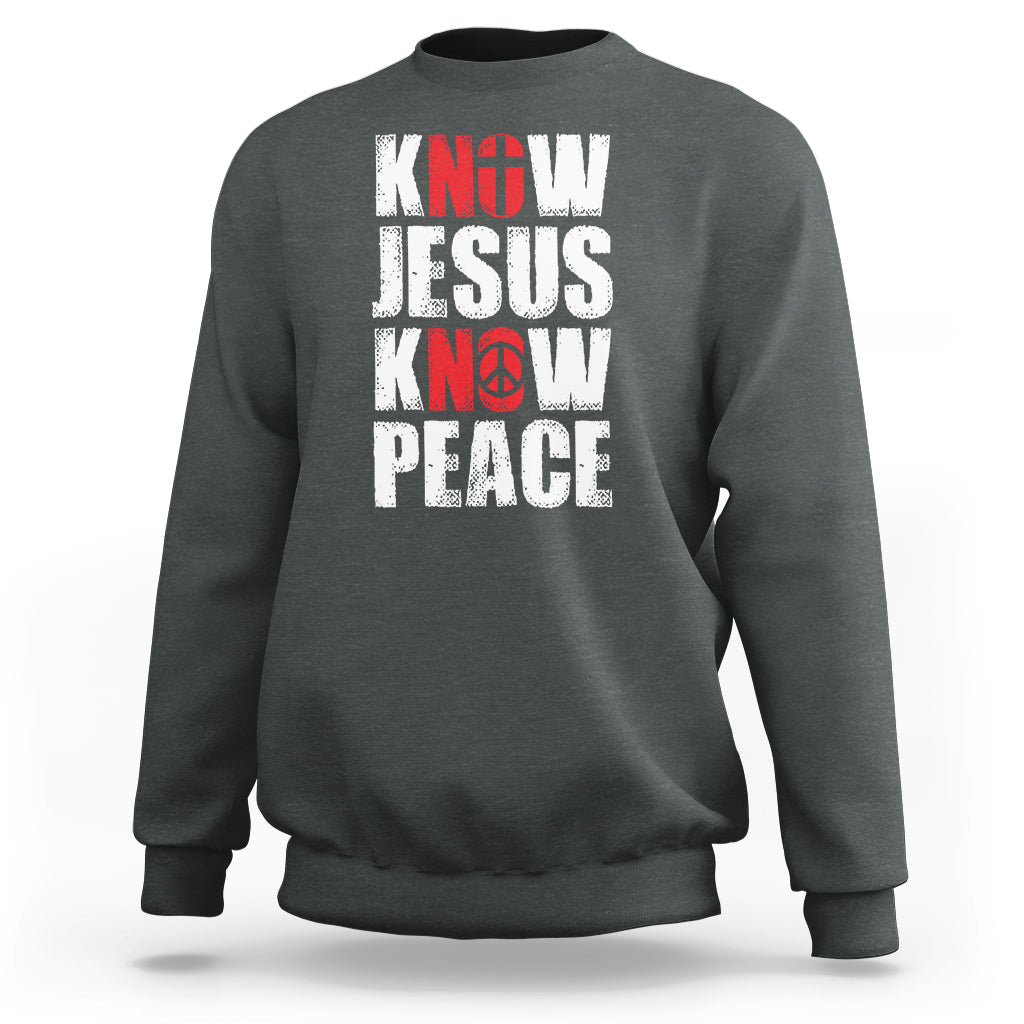 Dark heather sweatshirt with 'KNOW JESUS KNOW PEACE' graphic in white/red text.