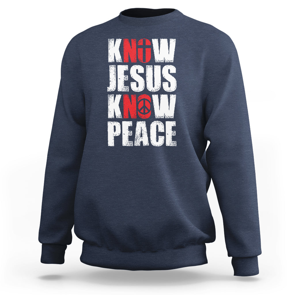 Navy sweatshirt with 'KNOW JESUS KNOW PEACE' graphic in white/red text.