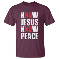 Maroon T-shirt with distressed "KNOW JESUS KNOW PEACE" graphic print