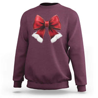 Maroon crewneck sweatshirt with red bow and white pom accents on chest