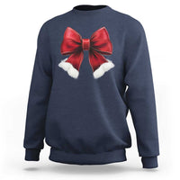 Navy crewneck sweatshirt with red bow and white pom accents on chest