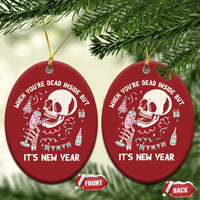 Two red oval Christmas ornaments with white skeleton graphic and “It’s New Year”