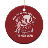Red round Christmas ornament with white skeleton, drink, and “It’s New Year” text