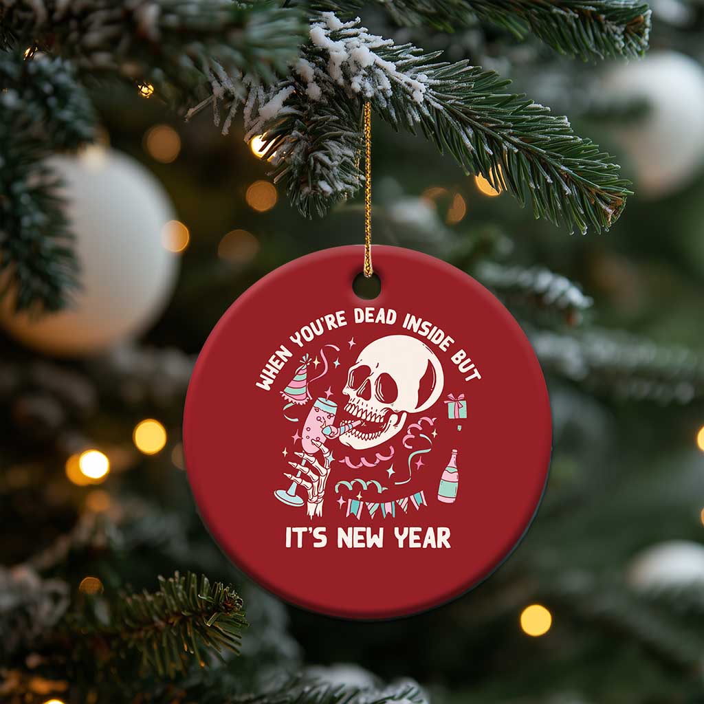 Red round Christmas ornament with white skeleton illustration and “It’s New Year”