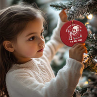 Red round Christmas ornament with white skeleton graphic and “It’s New Year” hanging