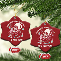 Two red Christmas ornaments with white skeleton graphic and “It’s New Year” text