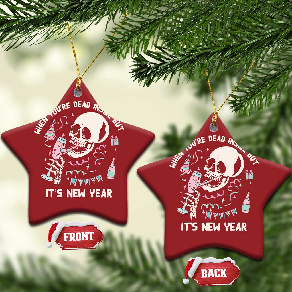 Two red star-shaped Christmas ornaments with white skeleton graphic and “It’s New Year”
