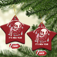 Two red star-shaped Christmas ornaments with white skeleton graphic and “It’s New Year”