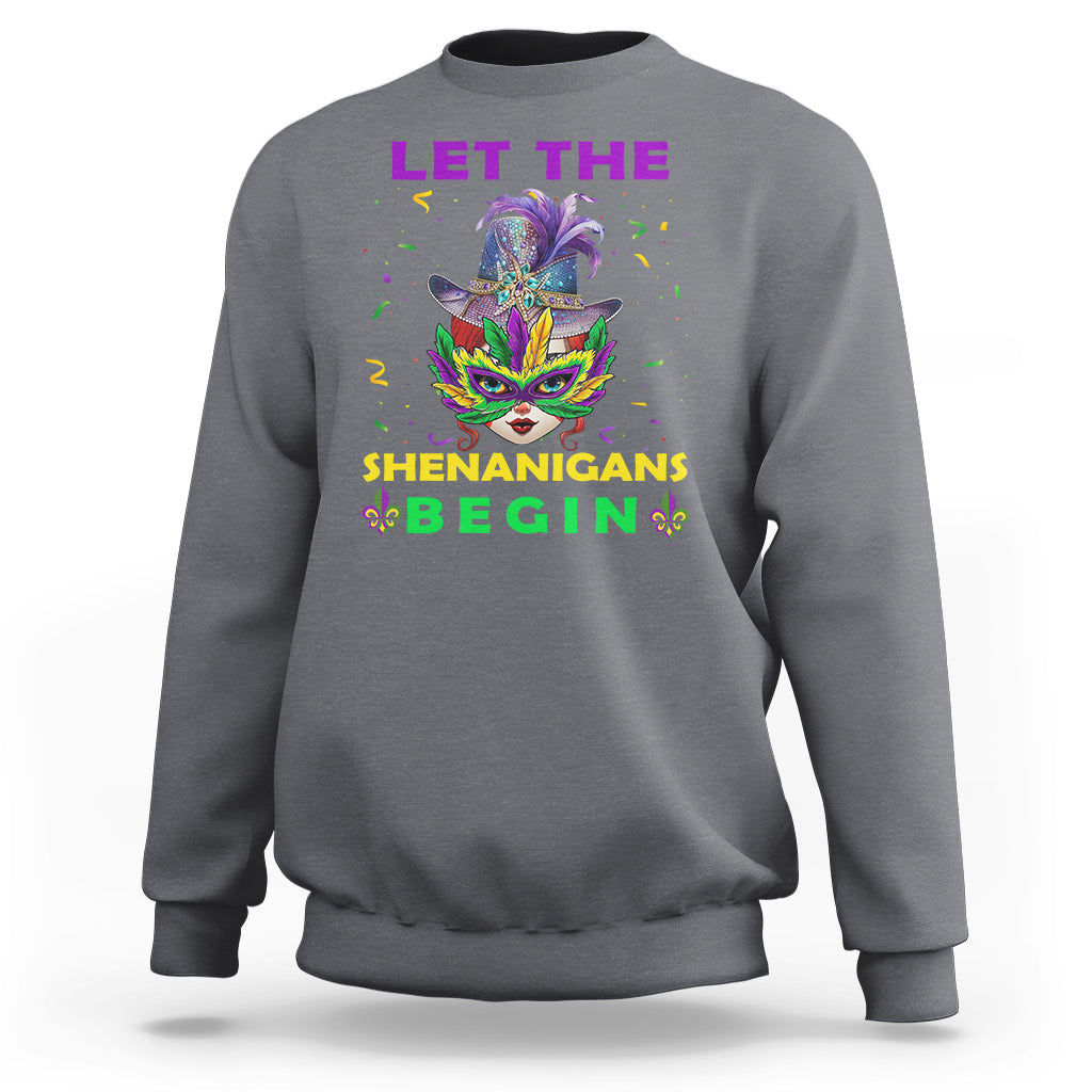 Charcoal gray crewneck sweatshirt with colorful Mardi Gras mask graphic and “LET THE SHENANIGANS BEGIN”.