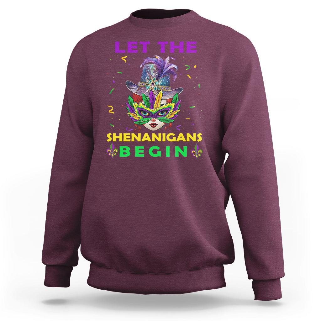 Maroon crewneck sweatshirt with colorful Mardi Gras mask graphic and “LET THE SHENANIGANS BEGIN”.