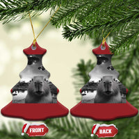 Two red and gray sweater-shaped Christmas ornaments with capybara and UFO graphic