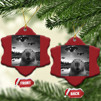 Two red scalloped Christmas ornaments with capybara and UFO graphic, hanging from gold strings