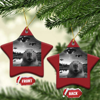 Two red star-shaped Christmas ornaments with capybara and UFO graphic, hanging from gold strings