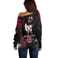 Women’s off-shoulder sweater in black with red skull print, long sleeves, back view.