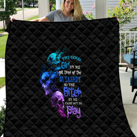 Black diamond-quilted throw blanket with multicolor skull and text graphic, full view