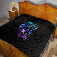 Black diamond-quilted comforter on bed with multicolor skull-and-text graphic