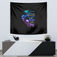 Black tapestry featuring multicolor skull graphic with stacked quote text