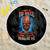 Black round beach blanket with fringed edge; red-blue skull with lightning, bold multicolor text