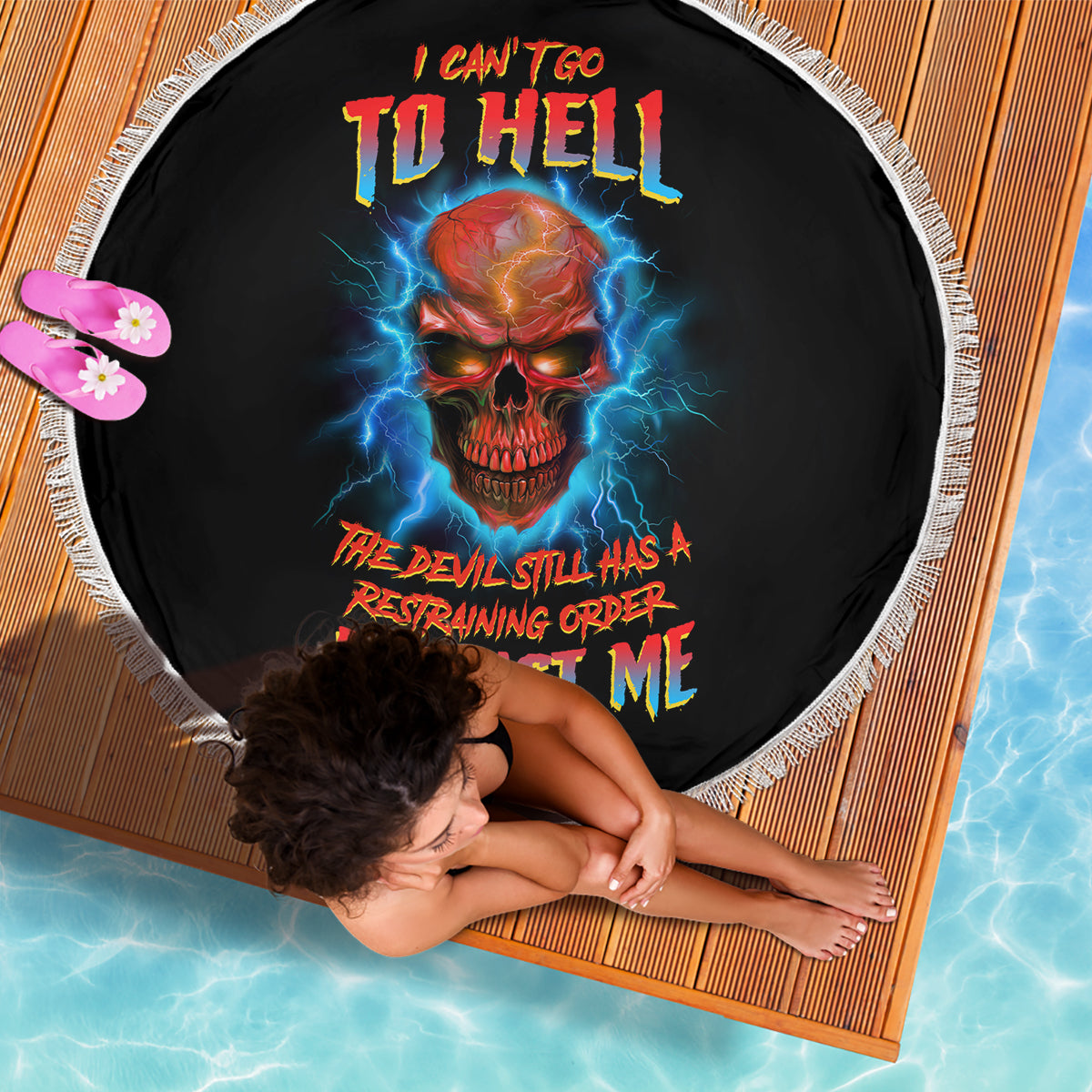 Black round beach blanket with fringed edge; fiery skull, lightning graphic, multicolor text