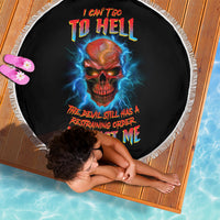 Black round beach blanket with fringed edge; fiery skull, lightning graphic, multicolor text