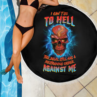 Black round beach blanket with fringed edge; skull artwork with blue lightning and multicolor text
