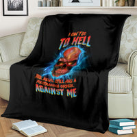 Black skull graphic throw blanket with blue lightning and multicolor slogan on striped couch