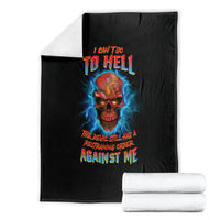 Black skull graphic blanket with blue lightning and multicolor text, folded with rolled blankets