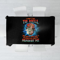 Black tablecloth with centered multicolor skull artwork and bold text design, neatly folded.