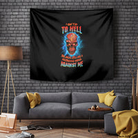 Black tapestry with skull graphic and colorful text, hanging on brick wall