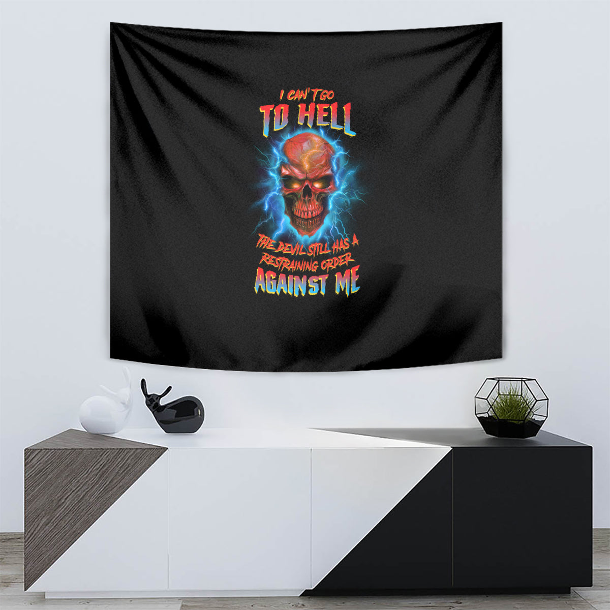 Black tapestry with skull graphic and colorful text, mounted above modern console